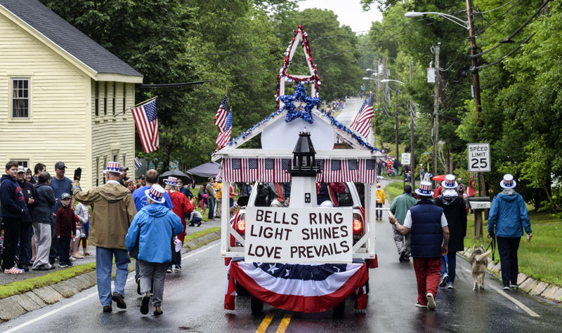 Members of the Wiscasset Congregational Church walk next to their float, which won the "most patriotic" category at the Wiscasset Fourth of July Parade on Sunday, July 4. (Nate Poole photo)