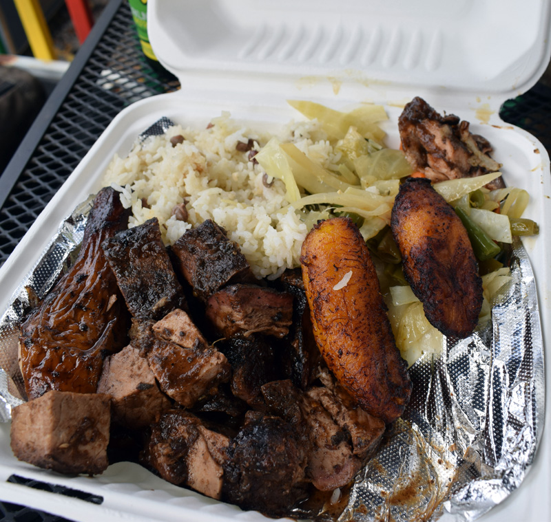 An order of jerk pork at J & J Jamaican Grocery in Damariscotta. For $18, a large to-go container is filled to the brim with the main dish and three sides: Sauteed vegetables, rice with peas, and fried plantains. (Evan Houk photo)