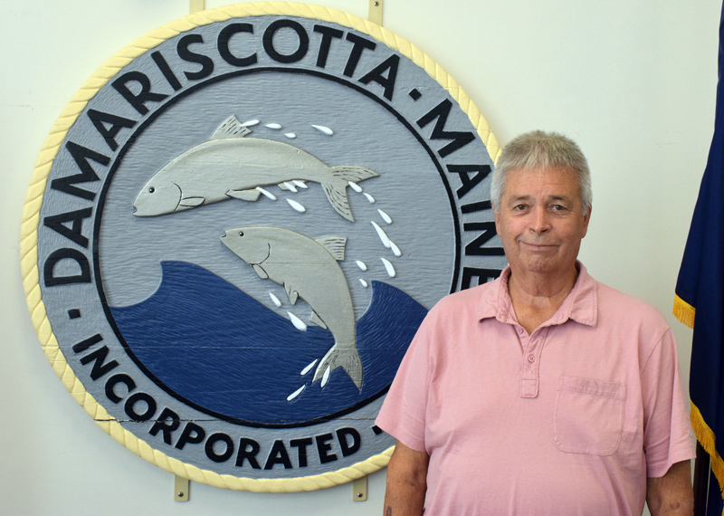 Code Enforcement Officer Stanley "Stan" Waltz stands in front of the Damariscotta town seal in the town hall on Friday, Sept. 24. Waltz is stepping back from his position in Damariscotta and Bremen, but will continue to work full-time for Waldoboro and Nobleboro. (Evan Houk photo)