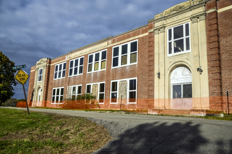 A temporary fence surrounds the A.D. Gray School in Waldoboro on Oct. 18. An engineering report determined that the brick facade is not attached to the front of the building and there is a risk that bricks could fall. (Bisi Cameron Yee photo)