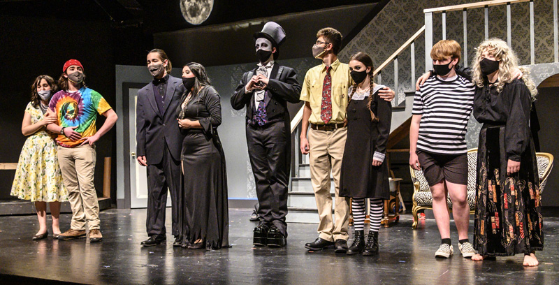 Kolyn Mattson as Lurch (center) makes a heart with his hands during the final scene of the dress rehearsal for Medomak Valley High School's presentation of "The Addam's Family" in Waldoboro on Oct. 23. (Bisi Cameron Yee photo)