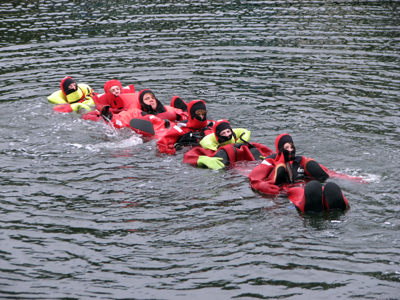 Swimming chain water survival in action. Pictured in their immersion suits from left: Nolan Gilbert, Spencer Gamage, Matt Hanna, Eben Lord, Tyler McFarland, and Caleb Soohey. (Courtesy photo)