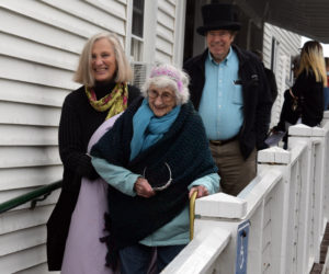 Dr. Chip Teel and Julie Terray assist a bundled-up Lila Blechman down the ramp from Hodgdon Green's porch at Hearts Ever Young's celebration of Blechman's 100th birthday. (Nate Poole photo)