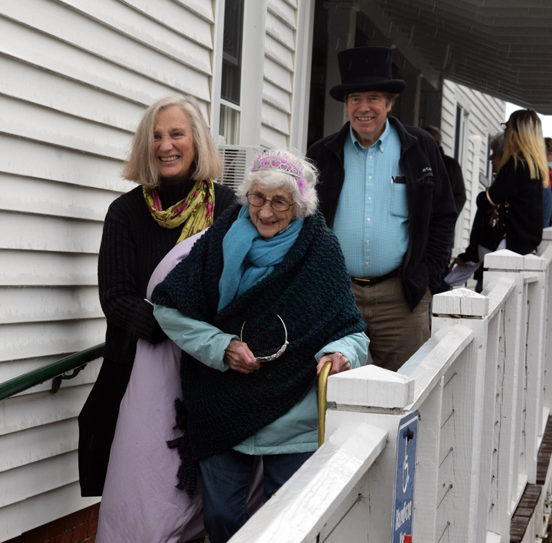 Dr. Chip Teel and Julie Terray assist a bundled-up Lila Blechman down the ramp from Hodgdon Green's porch at Hearts Ever Young's celebration of Blechman's 100th birthday. (Nate Poole photo)