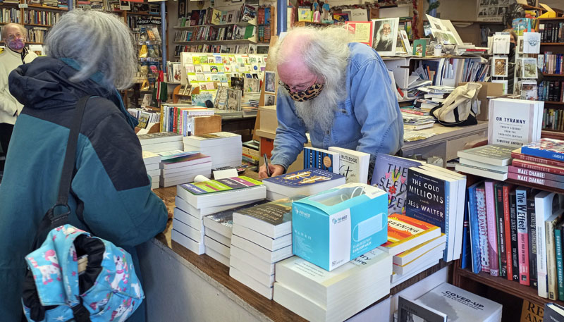 Poet Gary Lawless helps customers at his book store Gulf of Maine Books in Brunswick. (Emily Hayes photo)