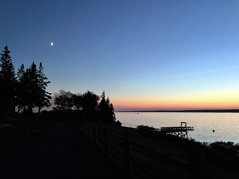 A first-quarter moon rises over Spruce Point in Boothbay Harbor on Nov. 9 as guests wait for the 200th-anniversary lighting of Burnt Island Lighthouse. (Raye S. Leonard photo)