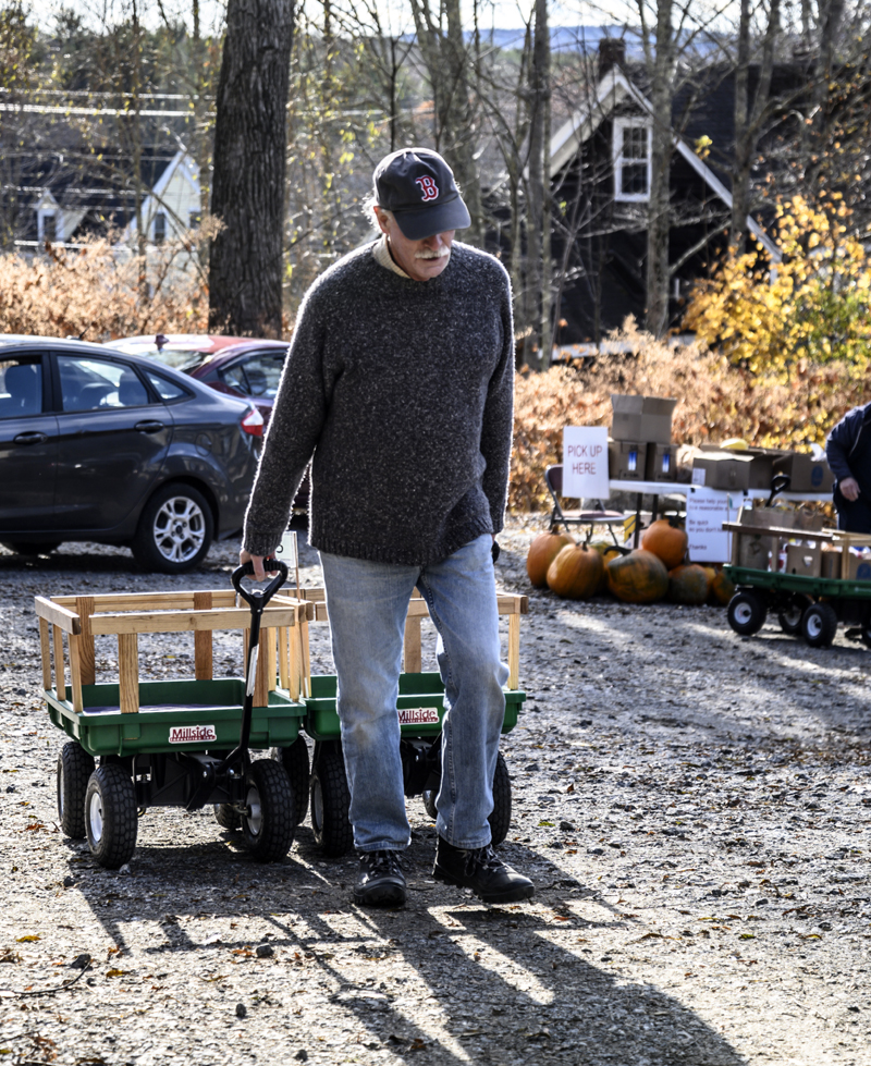 Andy Lackoff brings empty wagons back after helping take loads of food to a car that had broken down while on its way to the food pantry in Waldoboro on Nov. 16. (Bisi Cameron Yee photo)