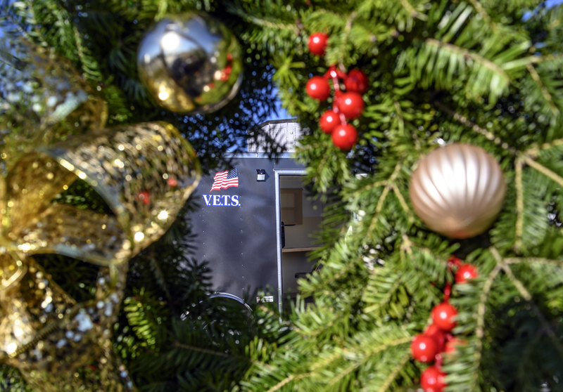 A trailer created as temporary housing for military veterans is seen through a wreath in Waldoboro on Nov. 20. Proceeds from the sale of the wreaths will go toward helping homeless veterans. (Bisi Cameron Yee photo)