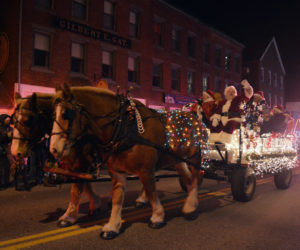 A team of horses pulls Santa Claus through downtown Damariscotta during the Parade of Lights in 2019. The popular parade returns to the Twin Villages on Nov. 26. (LCN file photo)