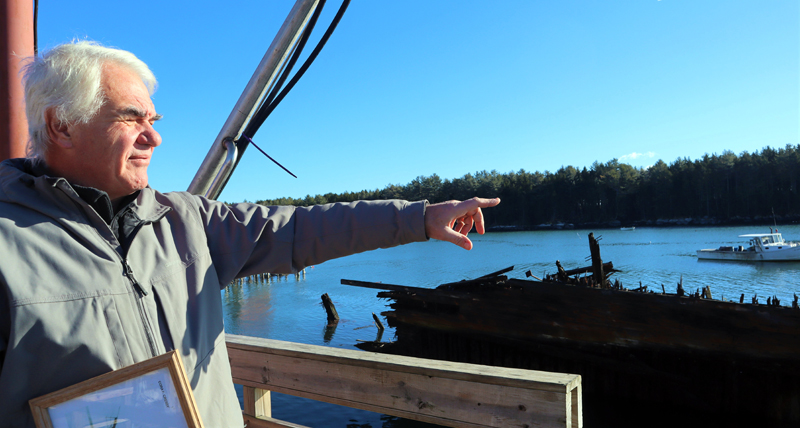 Boe Marsh, owner of Community Shellfish Company, points to where Medomak River meets Muscongus Bay in Bremen. (Emily Hayes photo)