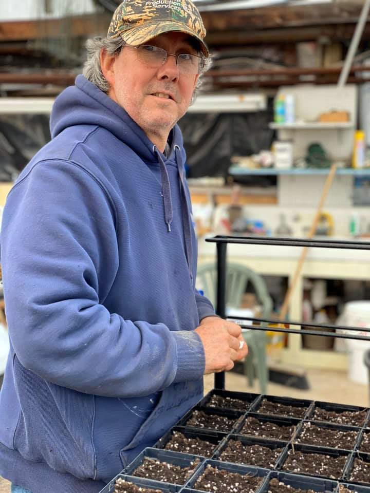 Bill Clark, co-founder of Damariscotta's Pumpkinfest and Regatta, mid-way through planting hundreds of pumpkin seeds in 2020. (Photo courtesy Damariscotta Pumpkinfest and Regatta)