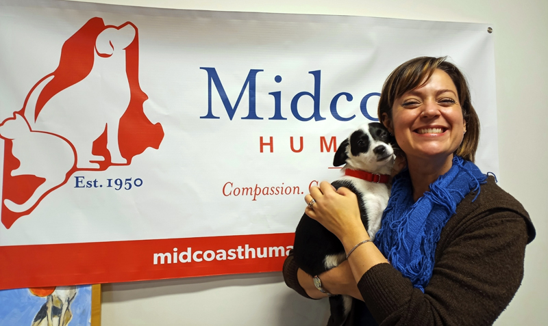 Executive director of Midcoast Humane Jess Townsend holding Ollie, a three-month-old puppy from Mississippi going up for adoption in Brunswick this week. (Emily Hayes photo)