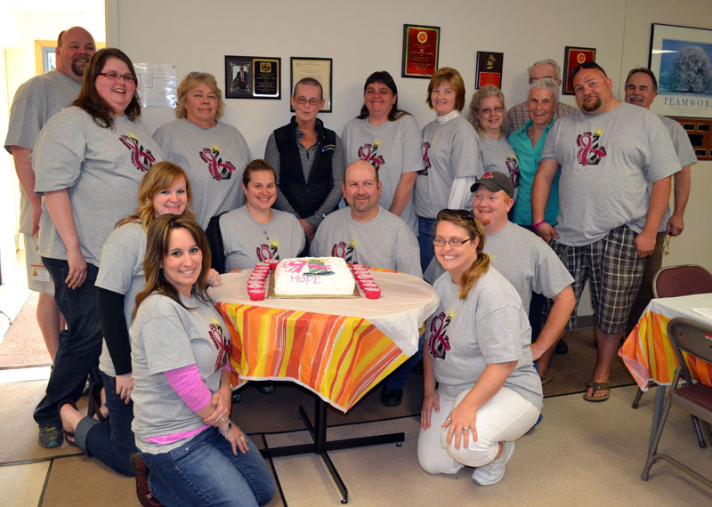 The Lincoln County Communications team in 2014.  Front row, from left: Melissa Temple and Teresa Grenie. Second row, from left: Nicole Merriman, Sarah Sherman, Mark Creamer, and Casey Stevens. Back row, from left: Rob Bickford, Emily Snowman, Pam Reed, Kathy Blagdon, Sonia Lilly, Tanya Bailey, Bobbie Robinson, Carol  Blodgett, Lincoln County Commissioner Bill Blodgett (partially hidden), Josiah Winchenbach, and Tod Hartung. (LCN file photo)