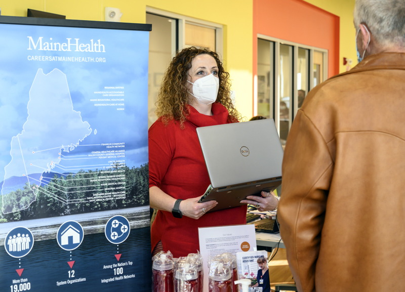 Sarah Evan greets a potential LincolnHealth employee during a job fair at the Central Lincoln County YMCA in Damariscotta on Nov. 16. (Bisi Cameron Yee photo)