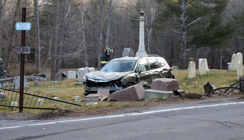 A firefighter investigates a 2020 Subaru Forester in the Glidden Cemetery on River Road in Newcastle following a collision on Dec. 13. (Nate Poole photo)