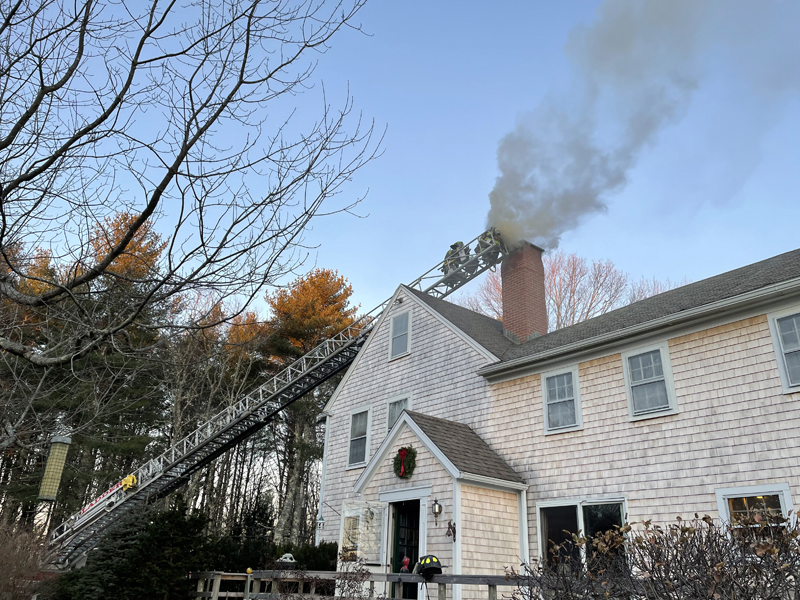 Firefighters work off Damariscotta Ladder 4 to extinguish a chimney fire. The fire was contained to the chimney. (Photo courtesy of Sgt. Erick Halpin, Damariscotta Police Dept.)