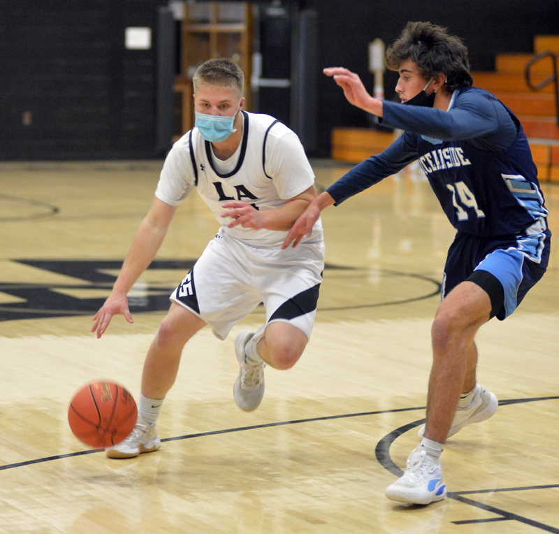 Jack Duncan controls action for the Eagles, as Alex Bartlett defends for Oceanside. (Paula Roberts photo)