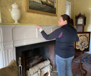 Floral designer Laura Tibbetts takes measurements of the Nickels-Sortwell House rooms in preparation for creating floral displays for tours during Wiscasset Holiday Marketfest. (Courtesy photo)