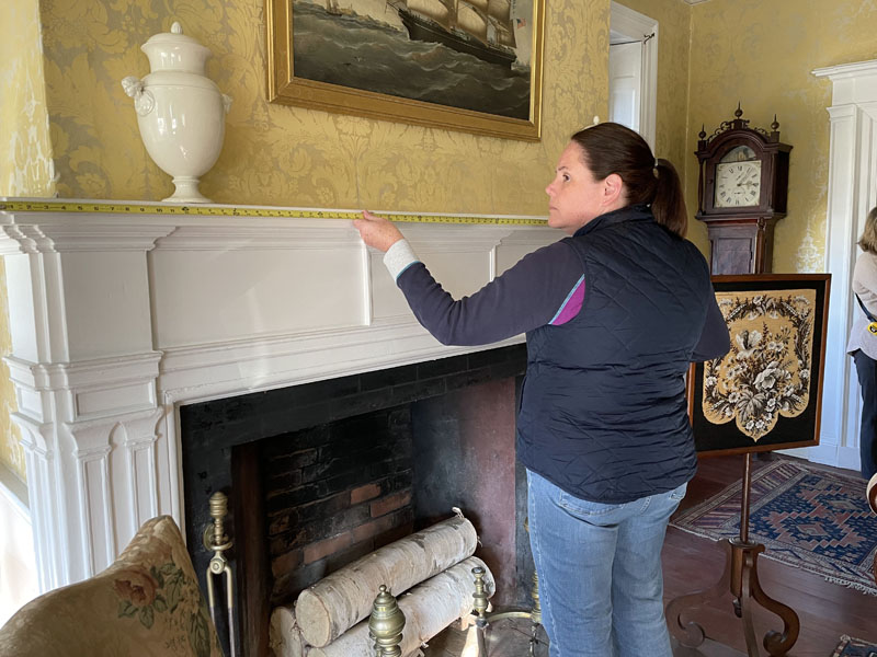 Floral designer Laura Tibbetts takes measurements of the Nickels-Sortwell House rooms in preparation for creating floral displays for tours during Wiscasset Holiday Marketfest. (Courtesy photo)