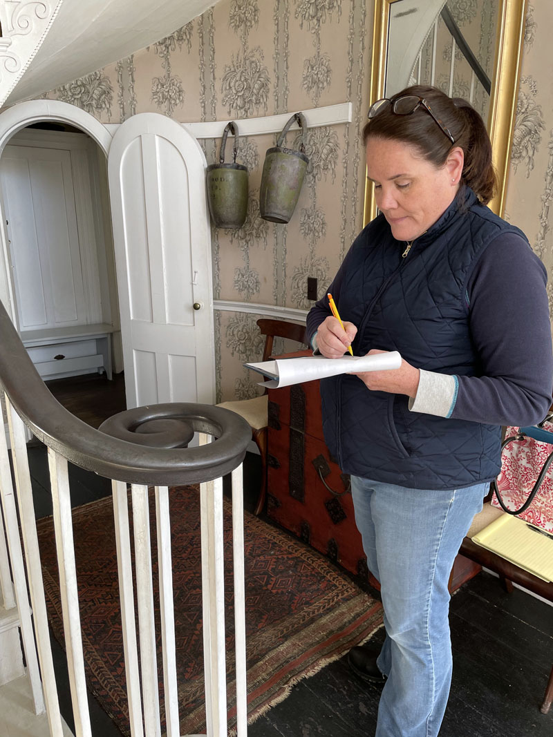 In the Nickels-Sortwell House front hall, floral designer Laura Tibbetts makes detailed notes for the seasonal displays shell create for tours during Wiscasset Holiday Marketfest. (Courtesy photo)