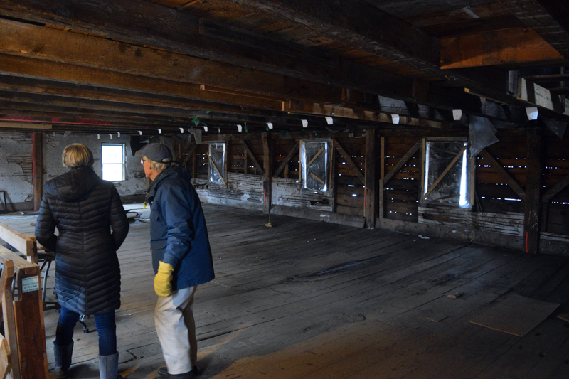Belinda Osier and Historical Society President Bobby Ives explore the second floor of the Mill at Pemaquid Falls on Jan. 13. (Nate Poole photo)