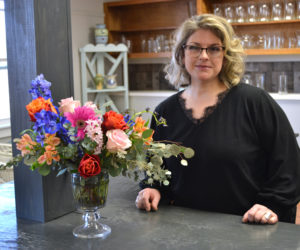 Jessica Newbert stands next to one of her arrangements in Willow Rose Flower Shoppe in Damariscotta. Newbert opened the shop at 521 Main St. in Damariscotta. (Maia Zewert photo)