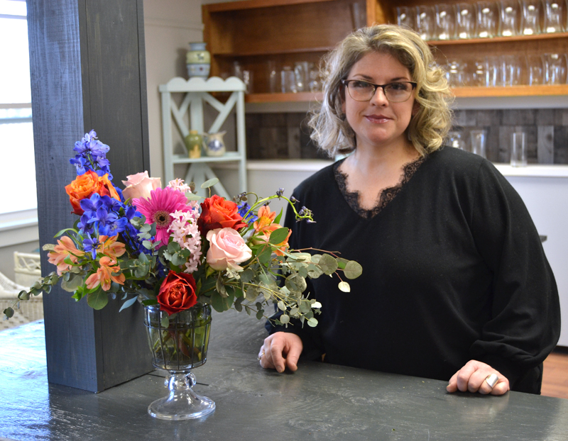 Jessica Newbert stands next to one of her arrangements in Willow Rose Flower Shoppe in Damariscotta. Newbert opened the shop at 521 Main St. in Damariscotta. (Maia Zewert photo)