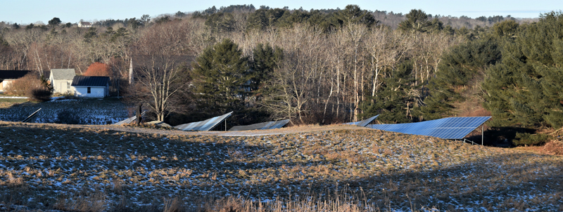 A ReVision Energy contractor walks along the access path to the new solar panels at Round Top Farm on Dec. 4. The panels are nestled in the southwest field behind Darrows Barn to reduce the visual impact of the installation. (Nate Poole photo)