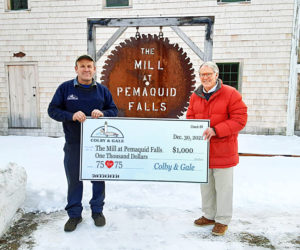 Verne Verney, of Colby & Gale Inc., presents a donation for The Mill at Pemaquid Falls to Old Bristol Historical Society Board President Robert Ives. (Courtesy photo)