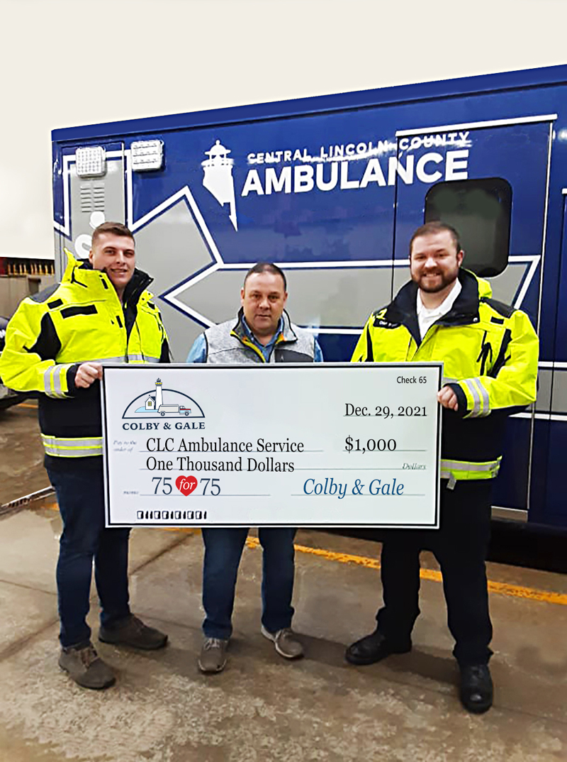 Colby & Gale Inc. General Manager Rob Wilkes (center) presents a donation for Central Lincoln County Ambulance Service to Service Chief Nicholas Bryant (right) and EMT Kobe Lincoln at its station in Damariscotta. (Courtesy photo)