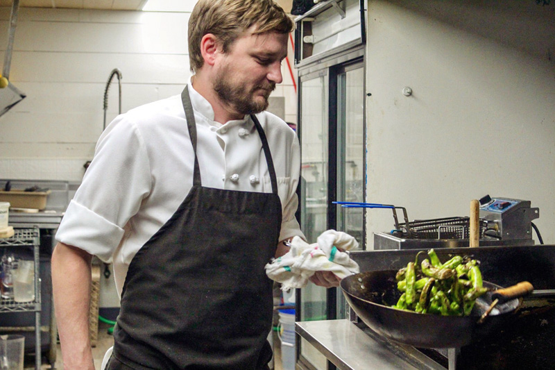 Bradley Inn Head Chef Ross Moskwa searing shishito peppers. (Photo courtesy Laura Moskwa)