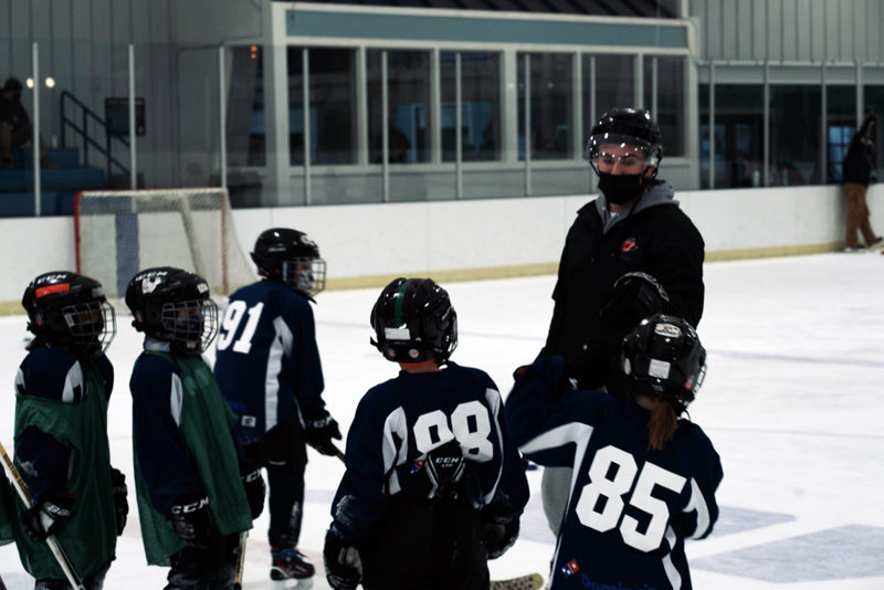 Joe Pollard, a retail analyst at Camden National Bank, volunteers time to coach hockey at Mid-Coast Recreation Center. (Courtesy photo)