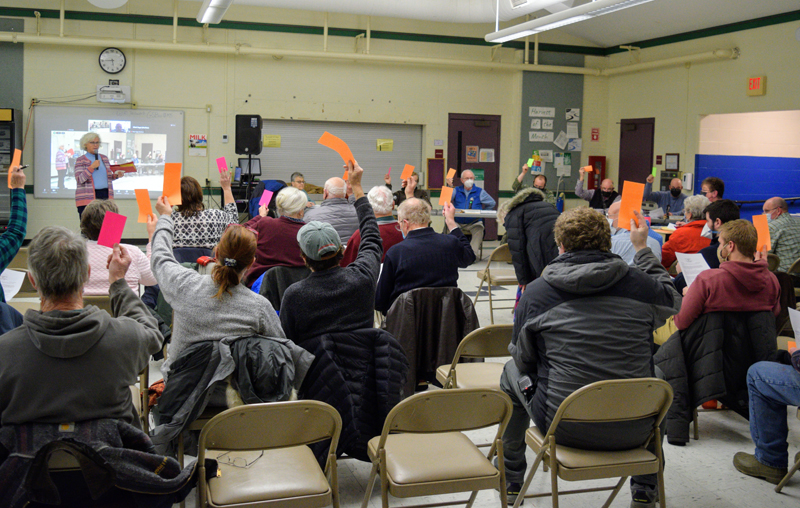 Damariscotta residents vote to pass an article at a special town meeting on Feb. 16 in the Great Salt Bay School cafeteria. (Nate Poole photo)