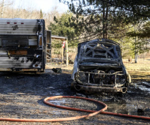 A burned out car rests next to a damaged trailer after catching fire in Edgecomb on Feb. 21. The owners of the vehicles were not home at the time of the fire. (Bisi Cameron Yee photo)