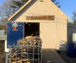 Justin Wood split wood in front of his sugar house on Lynch Road in Newcastle. He may use up to 60 bins full of split wood to fuel the boiler. (Anna M. Drzewiecki photo)