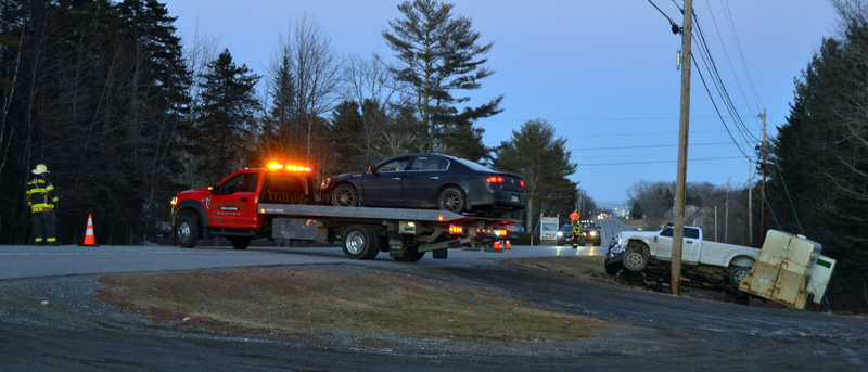 Hillside Collision Center removes a vehicle from the scene of a three-vehicle crash on Route 1 in Waldoboro the evening of Feb. 24. (Maia Zewert photo)