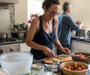 Erica Berman, front, of Veggies to Table, prepares vegetables in her Newcastle farm kitchen, as Kelsey Kobik preps behind her. (Photo courtesy Veggies to Table)