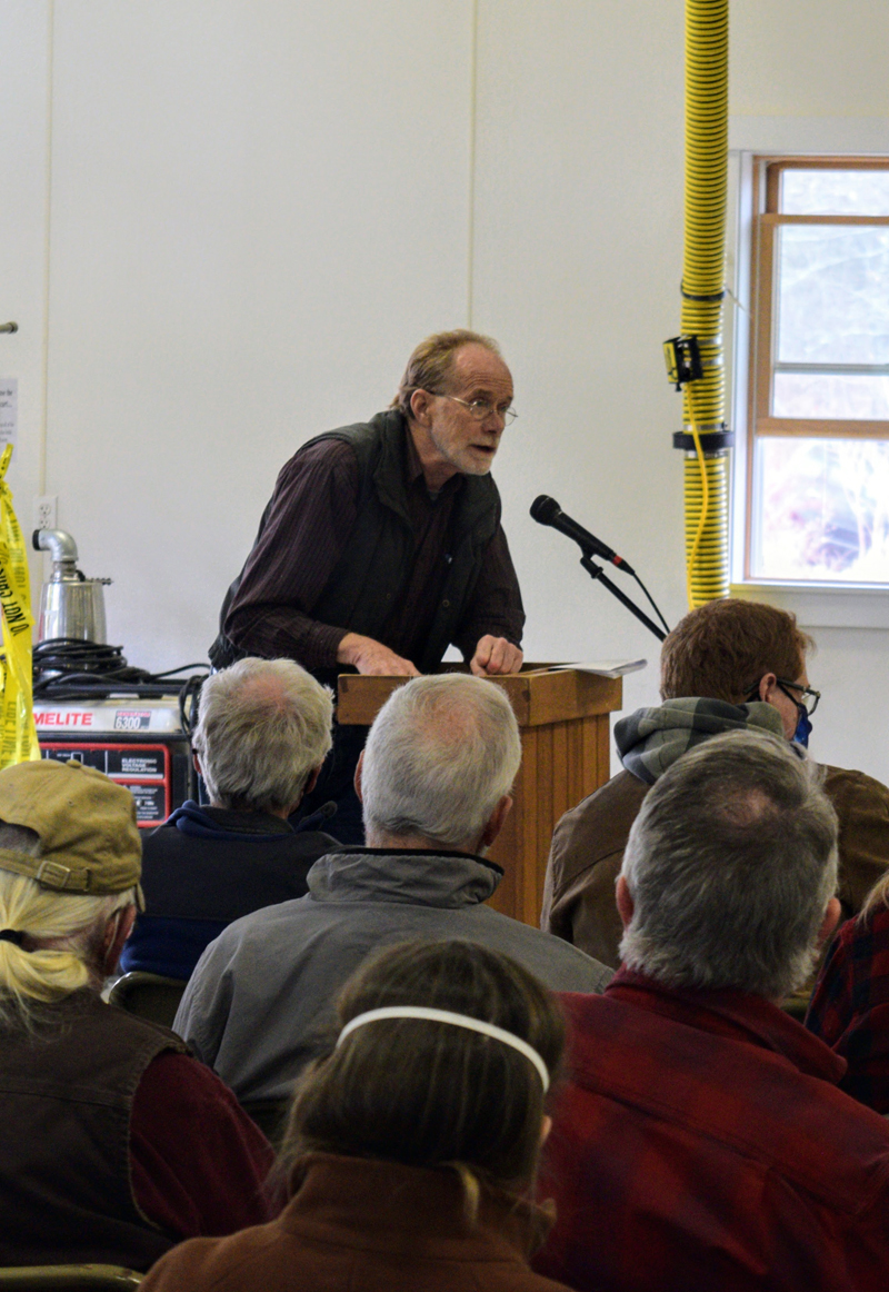 Former Alna Selectman Chris Cooper addresses an article on the town meeting warrant in front of voters on March 26. (Nate Poole photo)