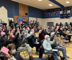 Bristol residents vote to approve one of 48 warrant articles during the annual town meeting in the Bristol Consolidated School gym on March 22. (Jason Pafundi photo)