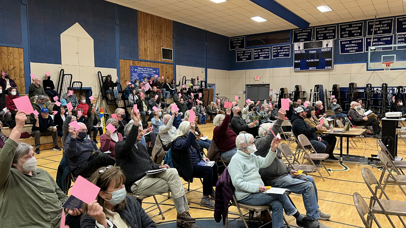 Bristol residents vote to approve one of 48 warrant articles during the annual town meeting in the Bristol Consolidated School gym on March 22. (Jason Pafundi photo)