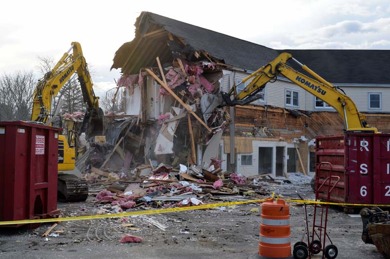 Excavators tear down the west wing of the former Damariscotta Bank and Trust operations building on the morning of March 15. (Nate Poole photo)