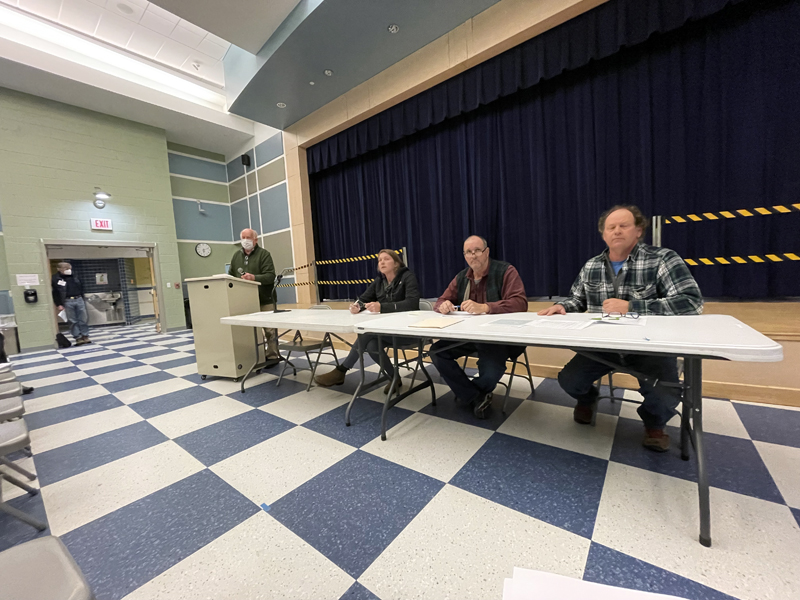 Don Means (left) moderates a public hearing in Jefferson as Selectmen Pam Grotton, Greg Johnston, and Jigger Clark share the annual town meeting warrant with residents. (Raye S. Leonard photo).