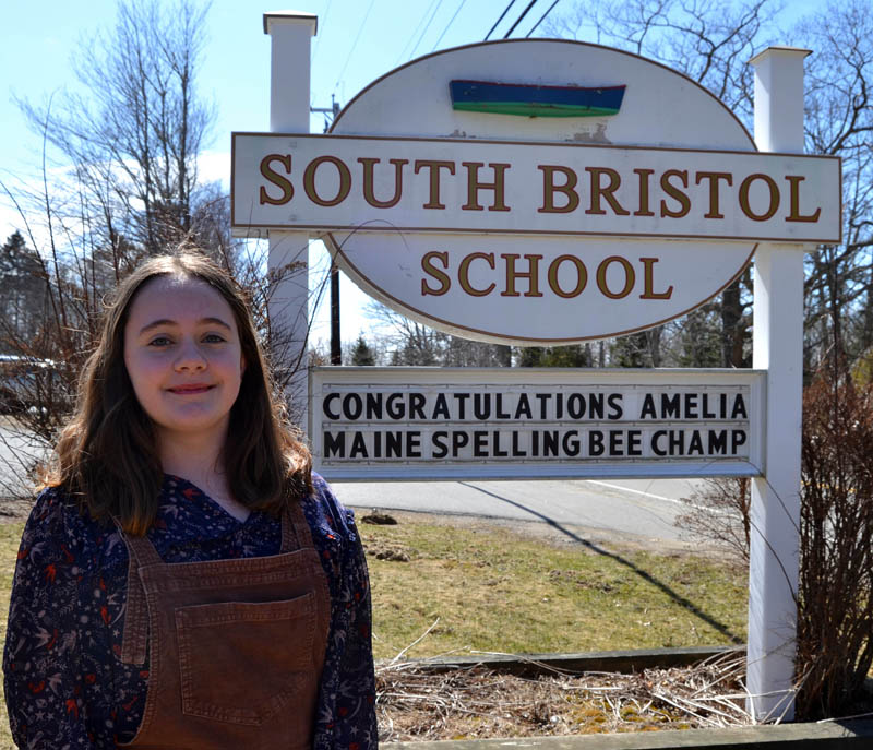 Amelia Rice stands in front of the South Bristol School sign, which celebrates her victory at the Maine State Spelling Bee. Rice, of Walpole, will compete in the Scripps National Spelling Bee in Washington, D.C. later this spring. (Maia Zewert photo)