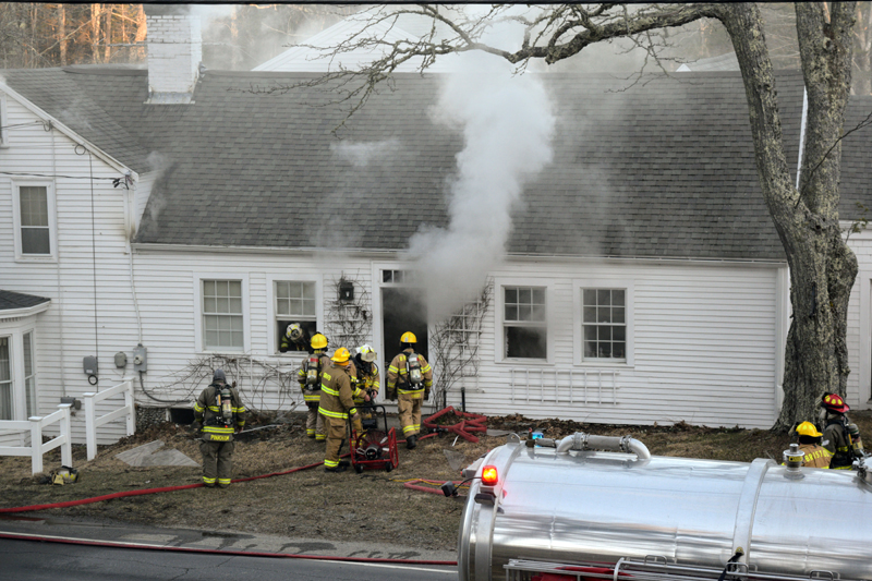 Firemen enter the smoke-filled Walpole Barn building on Route 129 in South Bristol on the morning of March 30. (Nate Poole photo)
