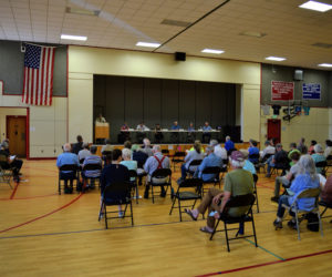 Whitefield residents review warrant articles during the annual town meeting at Whitefield Elementary School in June 2021. (LCN file)