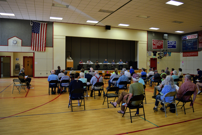 Whitefield residents review warrant articles during the annual town meeting at Whitefield Elementary School in June 2021. (LCN file)