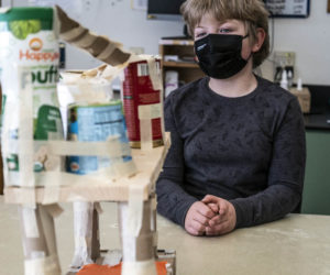 Francis Kahrl, 9, waits patiently for a tarantula to be introduced to one of his classmates' animal enrichment projects at the Chewonki Elementary and Middle School in Wiscasset on March 4. Students know to move slowly, and remain quiet and focused as they observe animal interactions with their designs. (Bisi Cameron Yee photo)