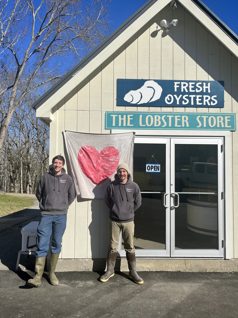 Andy Rogers, left, and Ryan Jolie stand in front of Scully's Sea Products on River Road in Edgecomb. They purchased the business from Barb Scully in January. (Anna M. Drzewiecki photo)