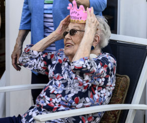 Eleanor Mitchell adjusts her birthday crown during her 100th birthday party in Damariscotta on Saturday, May 14. (Bisi Cameron Yee photo)