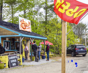 Customers line up at Larson's Lunch Box in Damariscotta on Saturday, May 21. The eatery opened for the season on Thursday, May 19. (Bisi Cameron Yee photo)